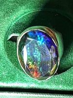 Front view of ring showing oval ammolite stone and silver band