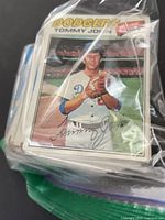 Front of stack showing Tommy John Dodgers card in plastic bag