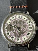 Close-up of Molnija dial showing ornate design, Roman numerals, small seconds