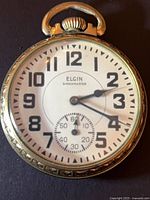 Front view of Elgin Shockmaster pocket watch showing dial and case