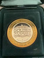 Obverse of Golden Nugget limited edition gaming token in case