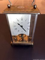 Front view showing full clock, brass frame and glass sides
