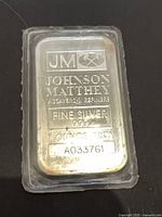 Front view showing Johnson Matthey hallmark, fineness, weight, serial number