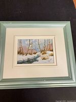 Full view of framed painting showing green frame and mats