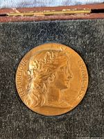 Obverse of bronze medal showing female bust and text