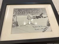 Full view of framed photo showing autograph and image