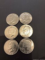 Obverse of six Eisenhower dollars