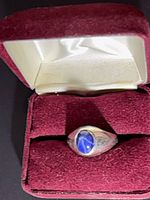 ring in open red velvet presentation box, front view of stone