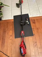Full view of Toro cordless trimmer with battery and charger