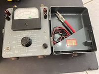 Northeast Electronics Corp Model TTS-28 multimeter with lid open showing test leads
