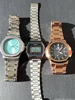 Three wristwatches side by side showing overall lot contents