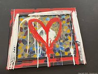 Front view of framed abstract painting showing red heart and multicolour background
