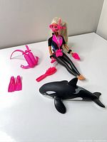 Full lot including Barbie doll, Keiko orca and accessories laid out