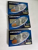 Front view of three sealed Memorex dB60 C60 cassette tapes