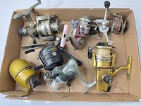 Box with seven assorted vintage fishing reels