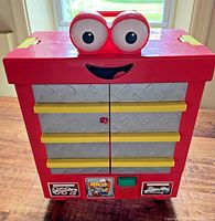 Front view of red Handy Manny Roland Talking Tool Chest showing eyes, mouth and doors