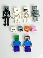 Front view of six Minecraft minifigures and four loose heads