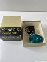 Flashgun with reflector inside open original box