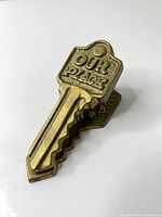 Top view showing key shape and "OUR PLACE" text