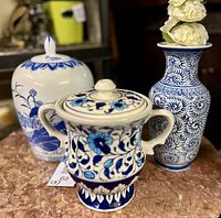 All three blue and white ceramic vases grouped together on surface