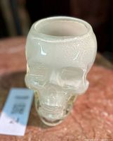 Top angled view of frosted glass skull planter showing open cavity and surface texture