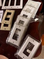 Assorted white and almond rocker plates, some sealed