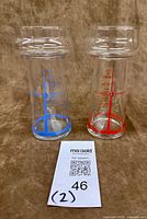 Both CN Tower cocktail glasses together showing red and blue print variants