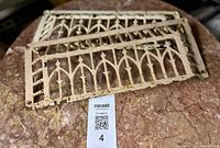 Both cast iron Gothic revival vent grates on table