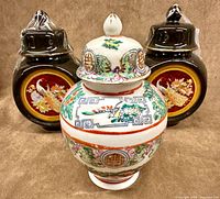 Frontal group view of three ginger jars showing relative sizes and designs