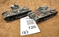 Both tank models side by side on fabric backdrop
