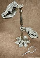 Full view of memo clip on stand with folding opera glasses beside base