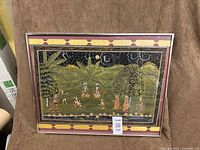 Full view of framed silk painting in metal frame