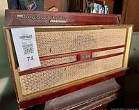 Front view of RCA Victor phonograph showing grille, knobs, logo, and lot QR tag