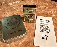 Lighter standing with presentation tin and auction card