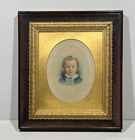 Full view of framed portrait showing outer wood frame and gilt inner frame