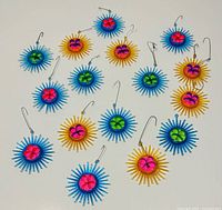 Group shot of 16 blue and yellow starburst ornaments