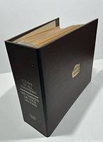 Closed binder showing spine title and emblem