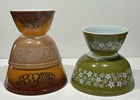 Stack of three brown/orange Orchard and Woodland bowls showing exterior motifs