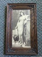 Front view of lithograph in oak frame showing subject and decorative corners