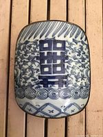 Top view showing porcelain shard with blue design and metal rim