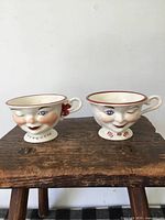 Both porcelain face cups side by side