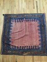 Full view of square woven textile showing overall design and size