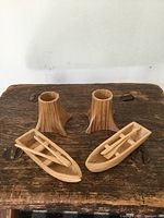 two canoes and two tree-stump holders on table