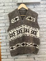 Front view of brown and cream Cowichan wool zip vest on hanger