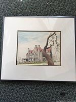 Front view of framed artwork showing castle scene, mat and frame