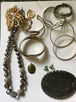 Full overhead view of all jewelry pieces on white background