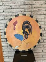 Front view of painted rooster roundel showing full artwork and border