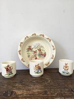 Front view of Bunnykins bowl and three egg cups