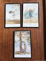 All three framed lithograph prints displayed on wood surface