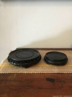 Two hardwood vase stands side by side